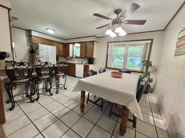 406 Campbell St, Daingerfield, TX 75638 - dining area with crown molding, light tile patterned floors, and a ceiling fan