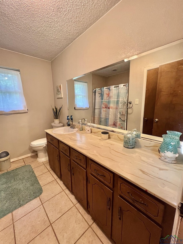 406 Campbell St, Daingerfield, TX 75638 - bathroom featuring vanity, tile patterned flooring, a textured ceiling, and a shower with curtain