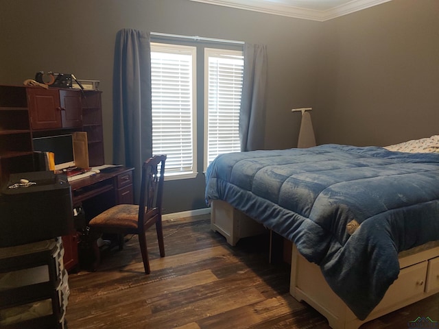 bedroom with dark wood finished floors, baseboards, and ornamental molding