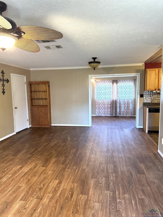 unfurnished living room with a textured ceiling, ornamental molding, and dark wood-type flooring