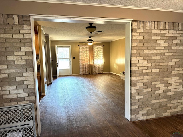 interior space featuring a textured ceiling, ceiling fan, dark hardwood / wood-style floors, and ornamental molding