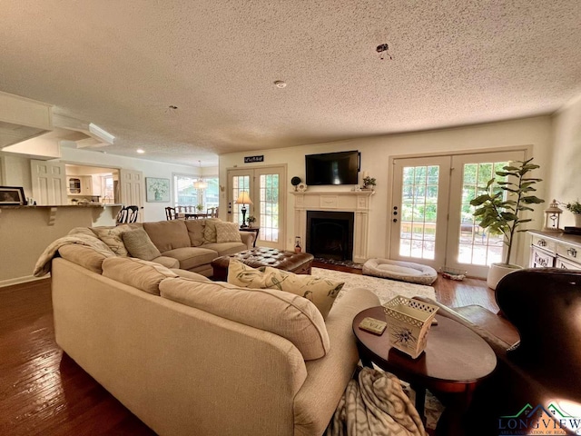 16 Pegues Pl, Longview, TX 75601 - living area featuring a textured ceiling, plenty of natural light, dark wood-type flooring, and french doors