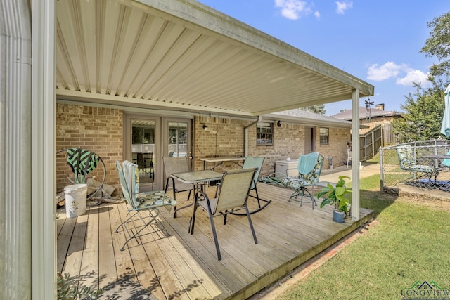 2202 Woodbine Dr, Gladewater, TX 75647 - wooden terrace featuring outdoor dining space, french doors, and a lawn