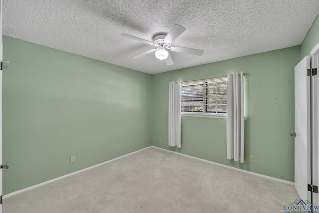 2202 Woodbine Dr, Gladewater, TX 75647 - unfurnished bedroom with carpet flooring, a textured ceiling, and a ceiling fan