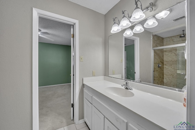 2202 Woodbine Dr, Gladewater, TX 75647 - bathroom featuring a textured ceiling, a stall shower, vanity, and tile patterned floors