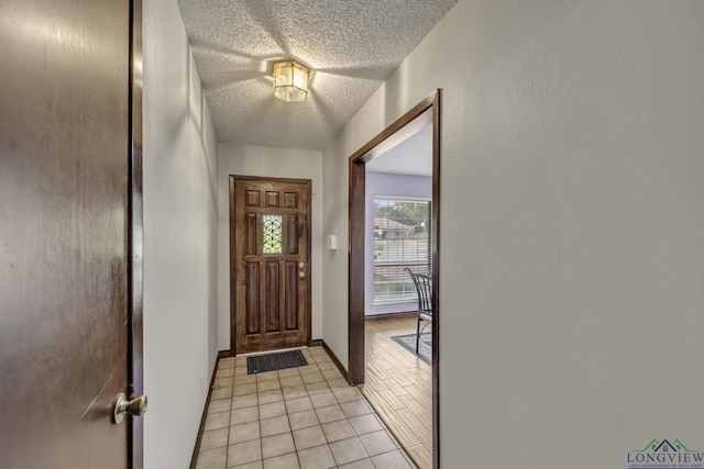 2202 Woodbine Dr, Gladewater, TX 75647 - entrance foyer featuring light tile patterned floors and a textured ceiling