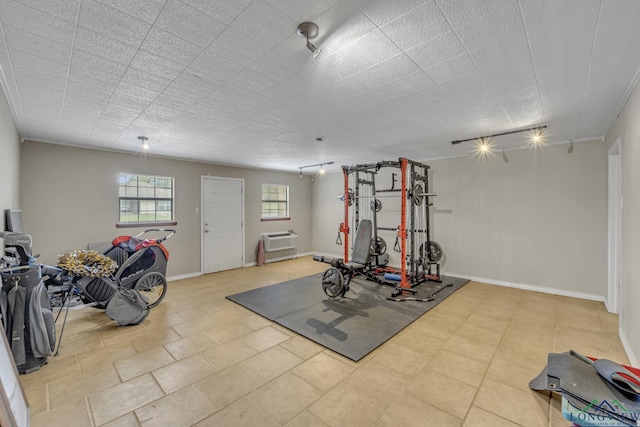 2202 Woodbine Dr, Gladewater, TX 75647 - workout area featuring baseboards and a wall mounted AC
