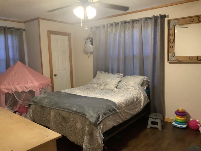 bedroom with ceiling fan, dark hardwood / wood-style flooring, and crown molding