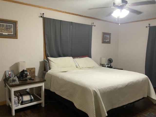 bedroom with dark hardwood / wood-style floors, ceiling fan, and ornamental molding