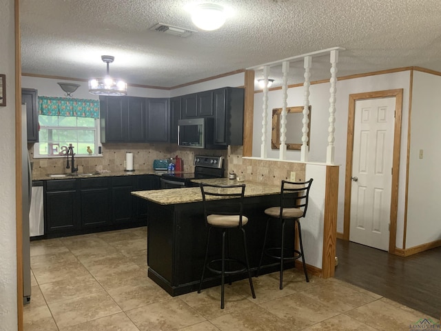 kitchen with light stone countertops, black electric range oven, crown molding, and sink