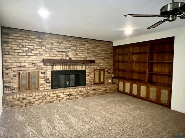 unfurnished living room featuring carpet flooring, ceiling fan, and a fireplace