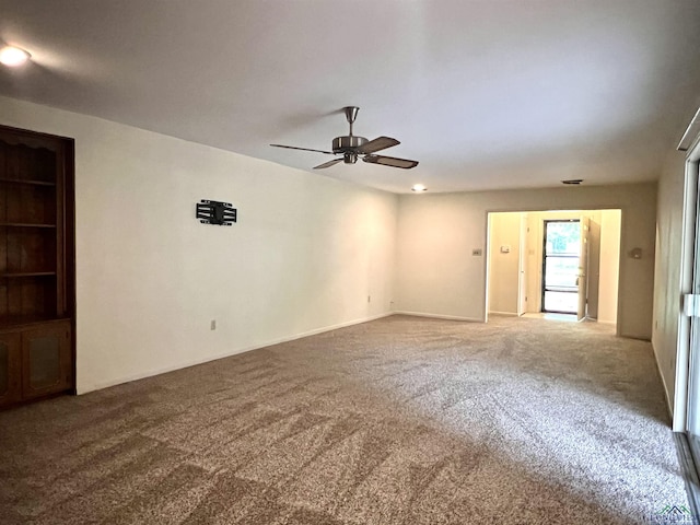 spare room featuring ceiling fan and carpet floors