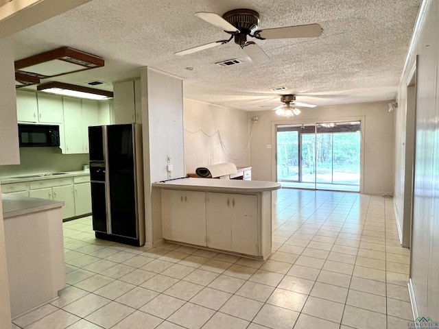 kitchen featuring black appliances, kitchen peninsula, ceiling fan, light tile patterned floors, and white cabinetry