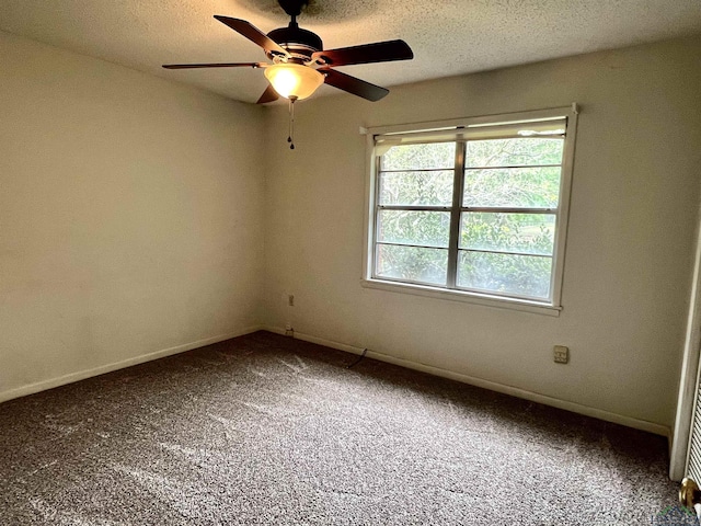 spare room featuring a textured ceiling, carpet floors, and ceiling fan