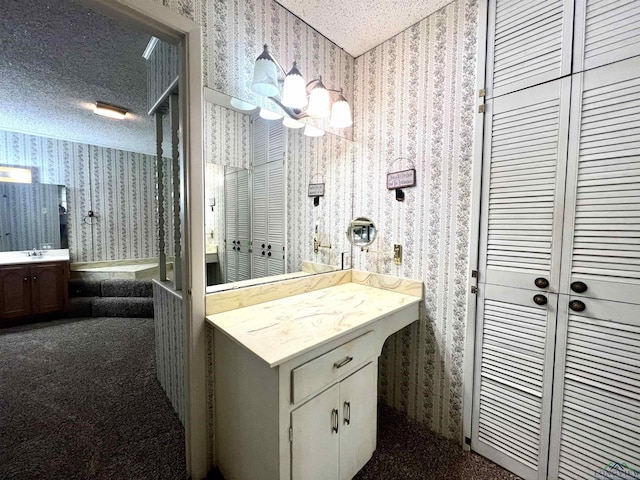 bathroom featuring vanity, a textured ceiling, and an inviting chandelier