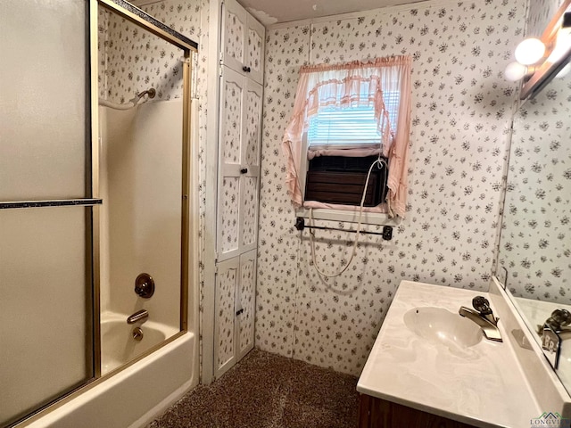 bathroom with vanity and bath / shower combo with glass door