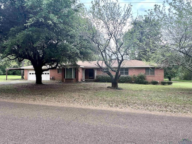 ranch-style home featuring a carport and a front lawn