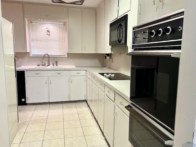 kitchen featuring white cabinetry, sink, light tile patterned flooring, and black appliances