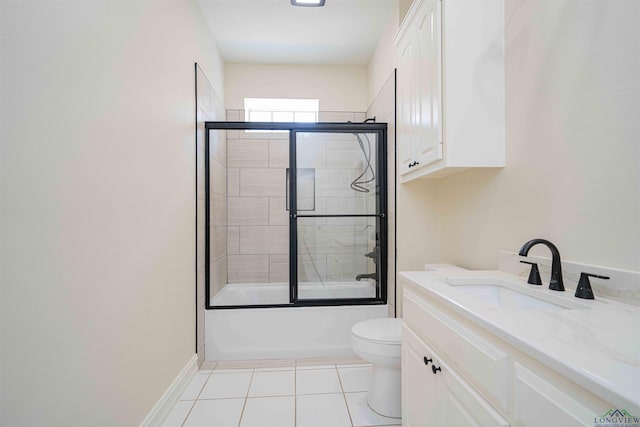 full bath featuring shower / bath combination with glass door, vanity, toilet, tile patterned floors, and baseboards