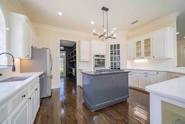 kitchen featuring visible vents, a sink, appliances with stainless steel finishes, and white cabinets