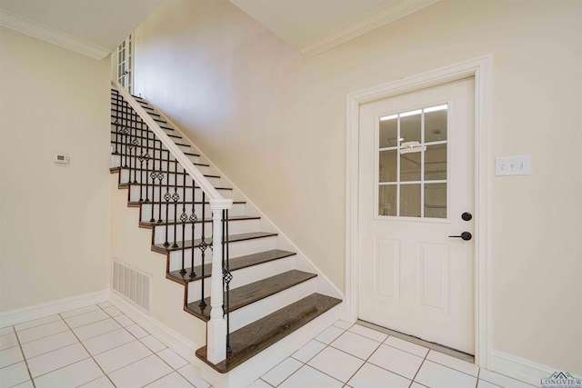 interior space featuring crown molding, stairs, baseboards, light tile patterned floors, and visible vents