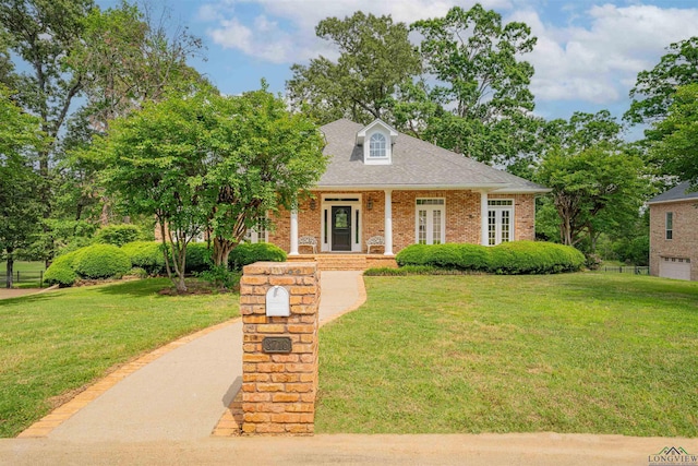 view of front of property featuring a porch, brick siding, and a front lawn