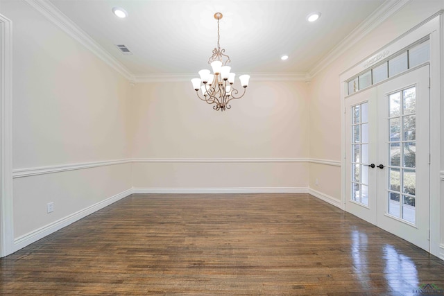unfurnished dining area featuring crown molding, a notable chandelier, wood finished floors, and visible vents