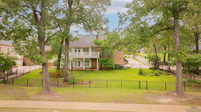 view of front of home with a fenced backyard and a front lawn