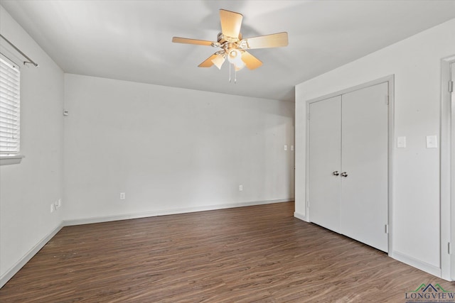 1800 Shady Ln, Longview, TX 75604 - unfurnished bedroom with wood finished floors, baseboards, and ceiling fan