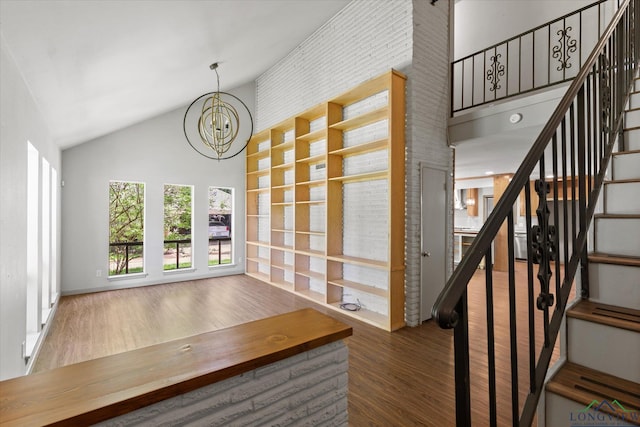 1800 Shady Ln, Longview, TX 75604 - stairway featuring a chandelier, wood finished floors, and high vaulted ceiling
