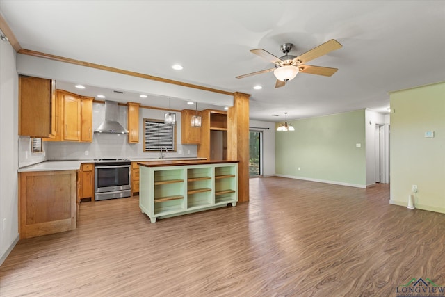 1800 Shady Ln, Longview, TX 75604 - kitchen featuring stainless steel stove, wall chimney exhaust hood, open shelves, light wood-style flooring, and baseboards