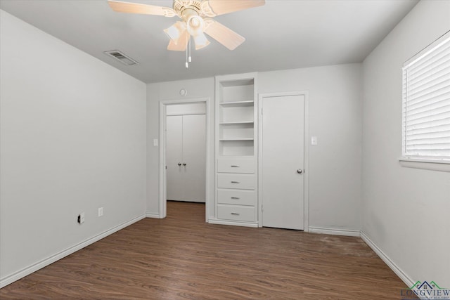 1800 Shady Ln, Longview, TX 75604 - unfurnished bedroom with wood finished floors, baseboards, and a ceiling fan