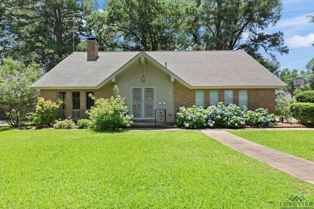 1800 Shady Ln, Longview, TX 75604 - view of front of house with a chimney, a front yard, and roof with shingles