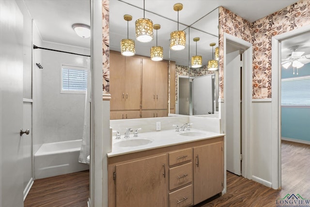 1800 Shady Ln, Longview, TX 75604 - bathroom with wood finished floors, double vanity, a ceiling fan, wallpapered walls, and baseboards