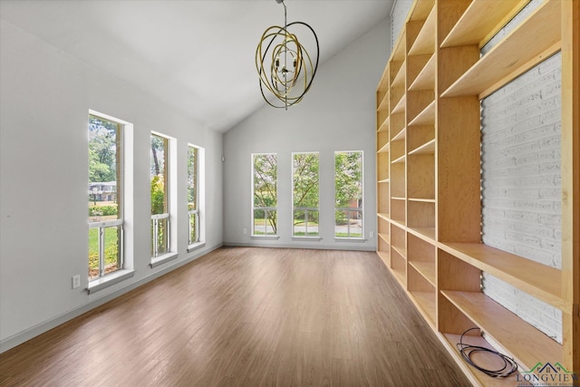 1800 Shady Ln, Longview, TX 75604 - spare room with healthy amount of natural light, a chandelier, wood finished floors, baseboards, and high vaulted ceiling