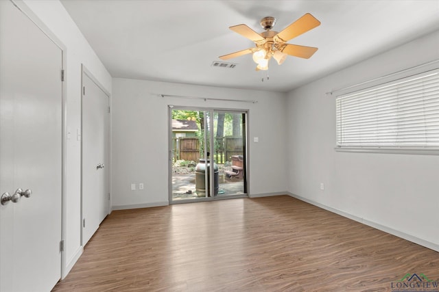 1800 Shady Ln, Longview, TX 75604 - spare room with wood finished floors, a ceiling fan, and baseboards