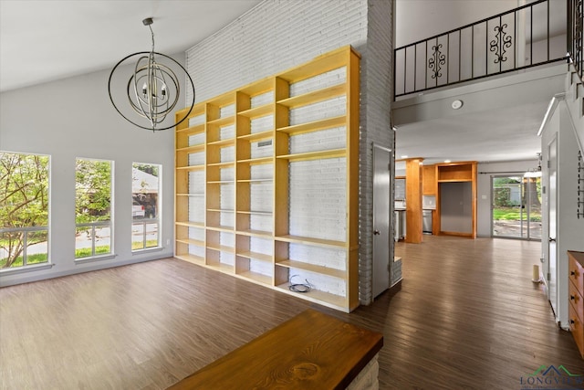1800 Shady Ln, Longview, TX 75604 - unfurnished living room with a towering ceiling, a chandelier, and wood finished floors