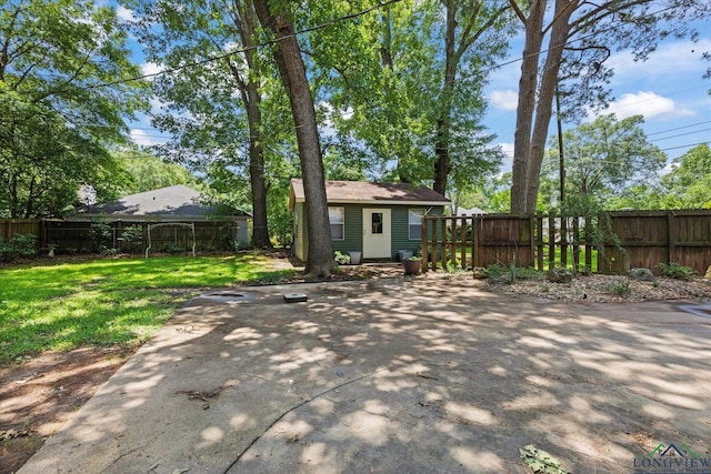 1800 Shady Ln, Longview, TX 75604 - back of house featuring an outbuilding and a patio area