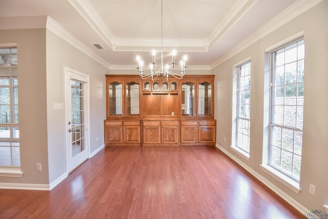 5816 Hollybrook Dr, Tyler, TX 75703 - unfurnished dining area with a chandelier, wood finished floors, a tray ceiling, baseboards, and crown molding
