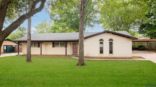 single story home with fence, a front yard, and brick siding