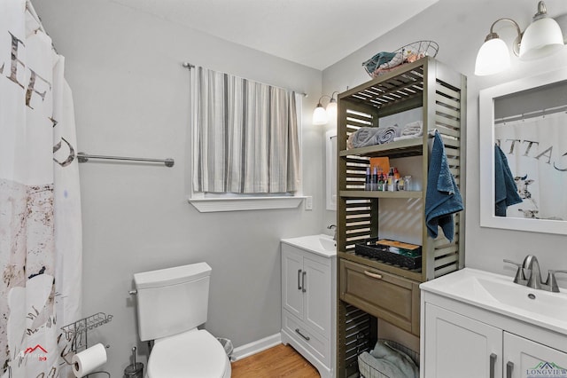 bathroom featuring hardwood / wood-style floors, vanity, and toilet