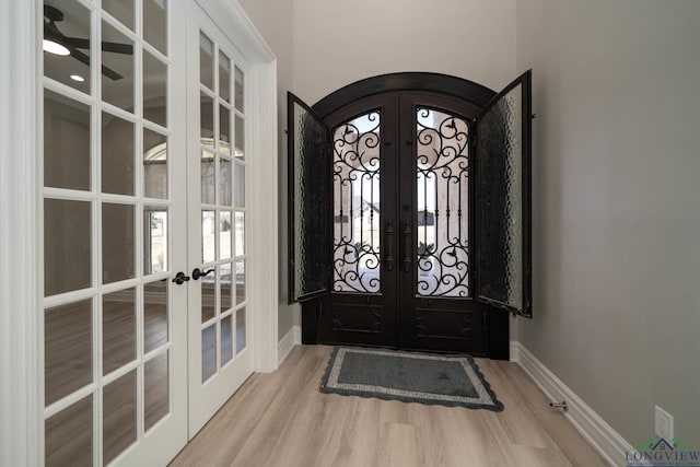 entryway with light hardwood / wood-style flooring and french doors