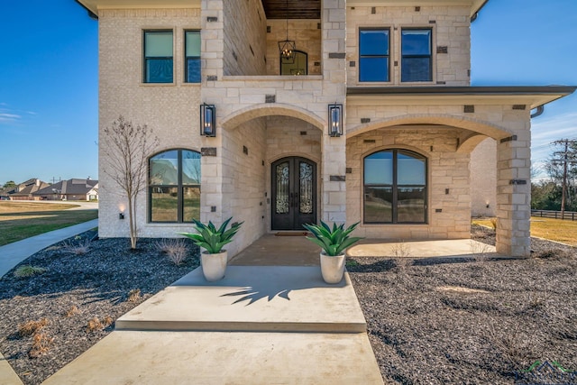 view of exterior entry featuring french doors