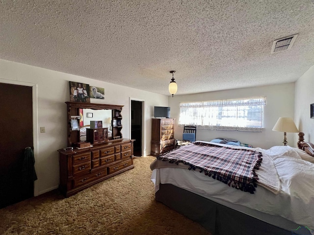 bedroom featuring a textured ceiling and carpet floors