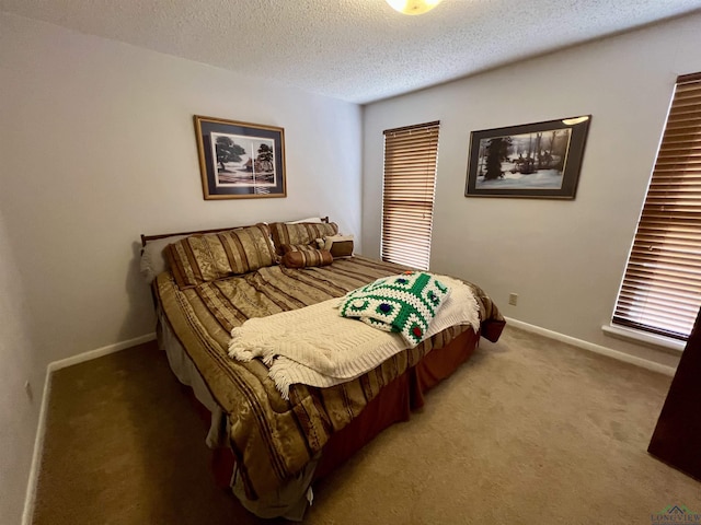 bedroom featuring a textured ceiling and carpet floors