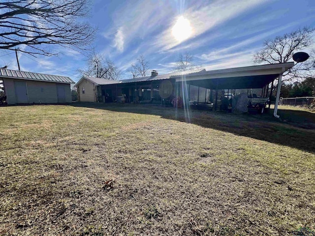 view of yard with a carport and an outdoor structure