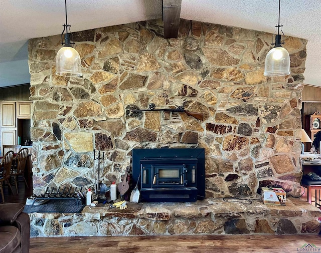 interior details with a textured ceiling and a wood stove