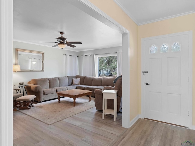 living room with light wood-type flooring, ceiling fan, and crown molding