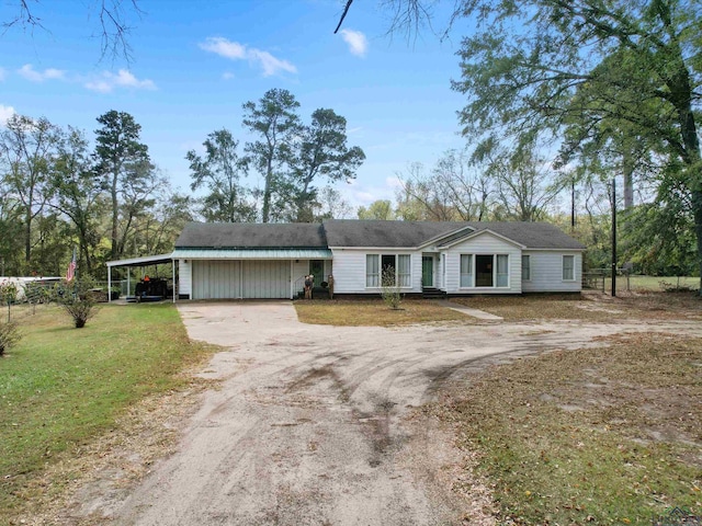 ranch-style home with a carport and a front yard