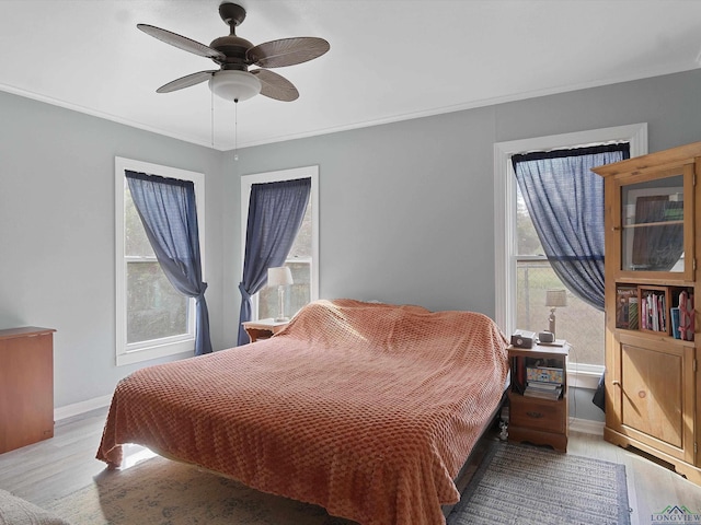 bedroom with ceiling fan and light hardwood / wood-style flooring